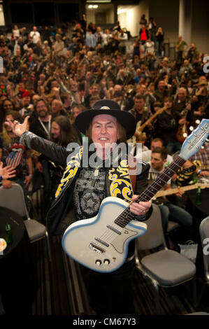 Coventry, UK. 'Strum a Chord for a good cause' event held on Sunday 14th October 2012 at the Ricoh Arena Coventry England UK The event, held in aid of Childline,  was an attempt to set a world record for the largest electric guitar ensemble. The ensemble  was led by Slade guitarist Dave Hill (in hat) Stock Photo