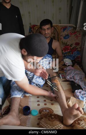 Azaz, Syria. 17th October 2012. A man gets his broken leg attended to after it was injured in a fighter jet attack in A'zaz, Syria on October 17, 2012. Credit:  PixelPro / Alamy Live News Stock Photo