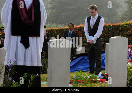 Kuala Lumpur, Malaysia. 18th October, 2012. Family members, British military personnel, and the British high commissioner pay their last respect during the burial of eight RAF crew members at the Commonwealth War Cemetery in Kuala Lumpur. The eight crew members were flying a B-24 Liberator on August 23, 1945, eight days after Japan surrendered in World War II, when the plane crashed and was lost near Kuala Pilah, Malaysia. Stock Photo