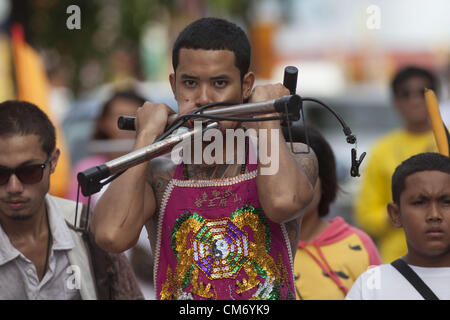 Oct. 19, 2012 - Phuket, Thailand - Devotees to the Chinese shrine of  Ban Tha Rue walk in a street procession at the annual Vegetarian Festival in Phuket, Thailand, Friday, Oct. 19, 2012. The annual traditional Chinese vegetarian festival  emphasizes merit making and ritual cleansing of the body to mark the nine-day-long festival featuring face-piercing, spirit mediums, and strict vegetarianism. (Credit Image: © David Longstreath/ZUMAPRESS.com) Stock Photo