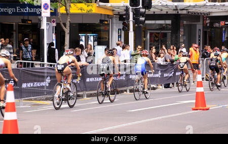 AUCKLAND, New Zealand- Oct. 20,2012: Women participants in the ITU World Triathlon Grand Finale Series cycle the main street of downtown Auckland. Stock Photo