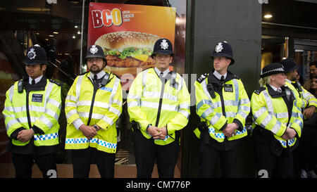 London, England, UK. Saturday, 20 October 2012. Police officers guard a McDonalds restaurant at the corner of Oxford Street and Tottenham Court Road. Protesters target shops and hotels in Central London after the TUC march where thousands gathered. Picture credit: Nick Savage/Alamy Live News Stock Photo