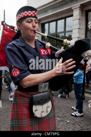 Scottish woman Fire Brigade Union member play bagpipe during Trade Unions' Coalition for Resistance anti-cuts rally in London Stock Photo