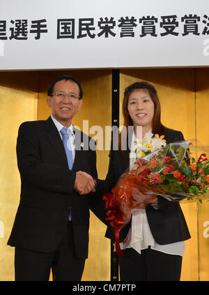 October 23, 2012, Tokyo, Japan - Saori Yoshida, right, Japan's three-time Olympic wrestling champion, shakes hands with Tomiaki Fukuda, president of the Japan Wrestling Fedreation, following a news conference in Tokyo on Tuesday, October 23, 2012. Japanese government decided to bestow the People's Honor Award on her for 'bringing hope and courage to society.' Yoshida,30, won a total of 13 Olympic and world titles in women's wrestling.  (Photo by Natsuki Sakai/AFLO) AYF -mis- Stock Photo