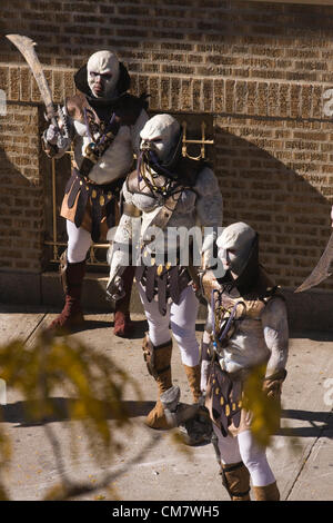 New York, USA. October 22nd 2012. O Positive Films. Three Actors dressed as Aliens standing on the sidewalk filming an on location movie on Wadsworth Avenue in the Inwood neighborhood of Manhattan in New York City Stock Photo