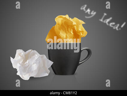 Crumpled colorful papers with coffee on black desktop. Stock Photo