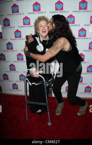 Oct. 27, 2012 - Beverly Hills, California, U.S. - PEGGY ALBRECHT gets a kiss from RUSSELL BRAND as they arrive for the Friendly House LA Annual Awards Luncheon Gala at The Beverly Hilton Hotel. Albrecht is Executive Director of Friendly House. (Credit Image: © TLeopold/Globe Photos/ZUMAPRESS.com) Stock Photo