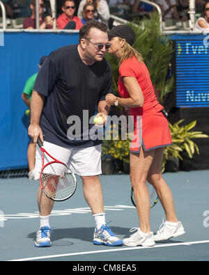 Oct. 27, 2012 - Delray Beach, FL, US - Tennis legend CHRIS EVERT whispers in the ear of  Actor TOM ARNOLD on court at the 2012 Chris Evert Pro-Celebrity Classic at the Delray Beach Tennis Center, Delray Beach, Florida. The Classic raises money for the Chris Evert Childrenâ€™s Hospital. (Credit Image: © Arnold Drapkin/ZUMAPRESS.com) Stock Photo