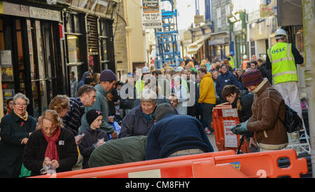 TOWN leaders have urged the Liskeard community to come together as it prepares to welcome retail guru Mary Portas back for the Big Clean Up this weekend. Hundreds gather to help with the Big Clean in Fore Street Liskeard. Saturday 27 10 2012 Picture By Sean Hernon. Stock Photo