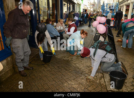 TOWN leaders have urged the Liskeard community to come together as it prepares to welcome retail guru Mary Portas back for the Big Clean Up this weekend. Hundreds gather to help with the Big Clean in Fore Street Liskeard. Saturday 27 10 2012 Picture By Sean Hernon. Stock Photo