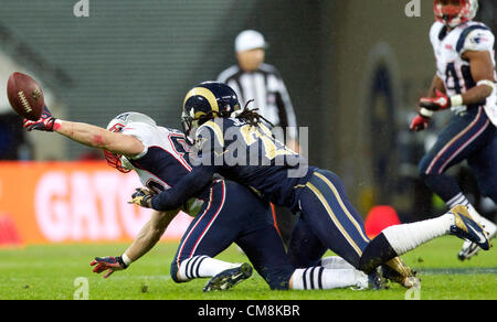 28.10.2012 London, England.  NE Patriots WR Wes Welker fumbles under pressure form Rams Trumaine Jenkins  during the NFL International Series 2012 game between The Bill Belichick and Tom Brady led New England Patriots and The St Louis Rams from Wembley Stadium. Stock Photo