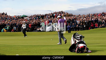 29.06.2012 Northern Ireland's Graeme McDowell holes a birdie putt on the last surrounded by spectators at the end of his second round of the Irish Open at Royal Portrush Golf Club in County Antrim, Northern Ireland.