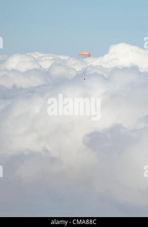 The Soyuz TMA-03M spacecraft is seen passing through clouds as it lands with Expedition 31 Commander Oleg Kononenko of Russia and Flight Engineers Don Pettit of NASA and Andre Kuipers of the European Space Agency July 1, 2012 in a remote area near the town of Zhezkazgan, Kazakhstan.  Pettit, Kononenko and Kuipers returned from more than six months onboard the International Space Station where they served as members of the Expedition 30 and 31 crews. Stock Photo