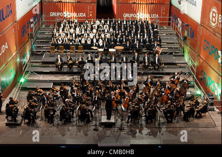 July 7, 2012 - Las Palmas, Canary Islands, Spain – Conductor Pedro Halffter, from Spain, The Philharmonic Orchestra of Gran Canaria and the Philharmonic Choir (OFGC) playing Beethoven's Ninth Symphony during 16th Las Palmas International Theatre, Music and Dance Festival. Stage built of 60 containers and 2 lifting cranes, at the waterfront in Las Palmas's port area and container terminal. Stock Photo