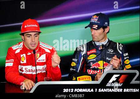 08.07.2012 Towcester, England. Runner Up Fernando Alonso of Spain and Scuderia Ferrari and Race winner Mark Webber of Australia and Red Bull Racing are interviewed at the post race press conference at the Santander British Grand Prix, Round 9 of the 2012 FIA Formula 1 World Championship at Silverstone Circuit. Stock Photo