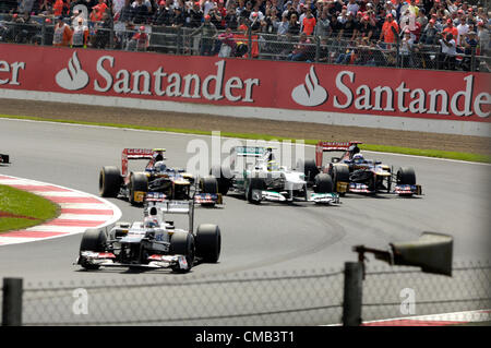 SILVERSTONE, UK, 8th July, 2012. Three abreast in Luffield corner at the Formula 1 British Grand Prix: Daniel Ricciardo and Jean-Eric Vergne's Toro Rosso cars each side of Nico Rosberg's Mercedes Stock Photo