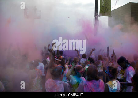 IOWA, USA. Sunday 8th July 2012. Color Me Rad race participants are covered in a cloud of colorful powder dyes during the final group 'color bombing' at the Council Bluffs, Iowa race. Color Me Rad combines a 5K run/walk with being showered with colorful cornstarch and dye and benefits the Special Olympics. Stock Photo