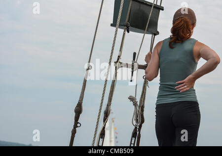 Alyssa Grinberg, from Boston, Massachusetts, a sailor on the crew of the schooner Tyrone, a tall ship from Chatham MA on Cape Cod, during a contemplative moment. Editorial use only. Stock Photo