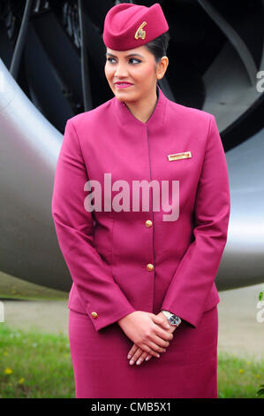 Farnborough, UK. Monday 9th July 2012.  Air stewardess welcoming guests to view the Qatar Airlines Boeing 787 'Dreamliner' on the first day of the Farnborough International Airshow 2012 where the Dreamliner is to have its first public flying display. It is seen as a rival to European Airbus. Qatar Airways will participate for the first time in flying displays at the airshow. Stock Photo