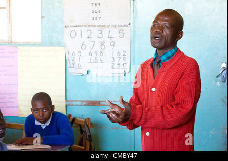 June 21, 2012 - Mhangura (Village, Zimbabwe - June 21, 2012, Makonde, Zimbabwe - A teacher teaches class at the Mhangura Mine Primary School in the Makonde District of Zimbabwe. CRS built 14 latrines at the school in 2011 through partner agency Caritas Zimbabwe, providing a healthy and hygienic school environment for the school's 1,197 students. CRS is implementing the Enhanced Rural Water Sanitation and Hygiene (ER WASH) project through Caritas in three districts of the country to improve household level health and hygiene. (Credit Image: © David Snyder/ZUMAPRESS.com) Stock Photo