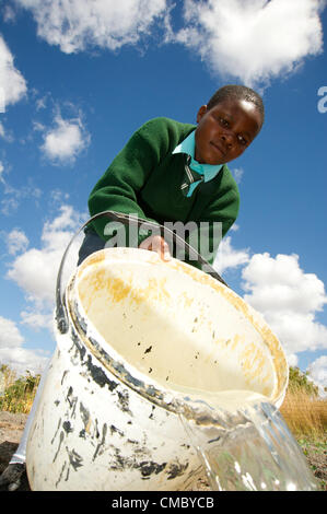 June 18, 2012 - Chikupo (Village, Zimbabwe - June 18, 2012, Murewa, Zimbabwe - A student of the Chikupo Secondary School in the Murewa District of Zimbabwe waters the school garden using water from the nearby elephant pump. Working through partner agency the Community Technology Development Trust (CTDT), CRS installed the pump in 2010 under the Protracted Recovery Program. Water and sanitation efforts are one part of that approach. (Credit Image: © David Snyder/ZUMAPRESS.com) Stock Photo