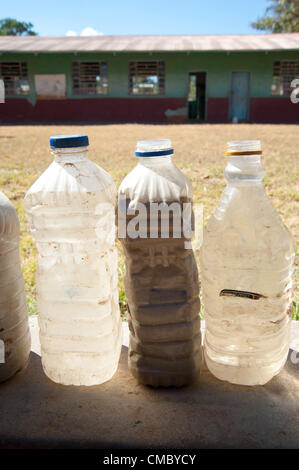 June 21, 2012 - Mhangura (Village, Zimbabwe - June 21, 2012, Makonde, Zimbabwe - Because water is unavailable at the school site, students of the Mhangura Mine Primary School in the Makonde District of Zimbabwe bring water to class for use in washing their hands. CRS built 14 latrines at the school in 2011 to help with sanitation as part of the Enhanced Rural Water Sanitation and Hygiene (ER WASH) project, being implemented through Caritas Zimbabwe. (Credit Image: © David Snyder/ZUMAPRESS.com) Stock Photo