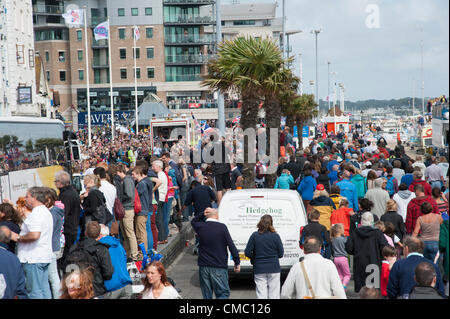 Poole, UK. 14 July, 2012. Crowds pack Poole Quay as the Olympic Torch Relay passes along it on day 56 of the Torch's round Britain journey Stock Photo