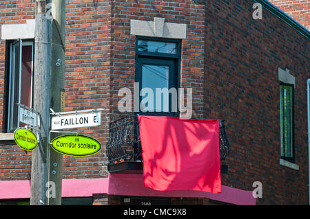 Red squares on houses of Villeray sector in Montreal Canada- These are In support of Quebec's massive ongoing student strike that started on February 13, 2012 - Supporters are showing on houses, clothes and other venues the symbolic red square called “Carrément dans le rouge”  The translation means “Squarely in the red” and is a French wordplay meaning the students are trapped in debt because of raise in school tuition/So while it is holiday season for most the indefinite strike goes on. Stock Photo