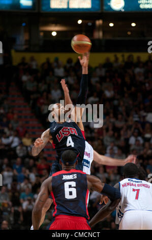 Manchester Evening News Arena, Manchester, UK. Thursday 19th July 2012. Tyson Chandler, number 4, of the USA jumping at the tip off of their Olympic 2012 warm up match against Great Britain at the Manchester Evening News Arena. LeBron James is watching. Credit: Colin Edwards/Alamy Live News Stock Photo