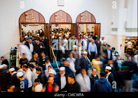 London, UK - 20 July 2012: London's Muslim faithful exit the East London Mosque during the first day of Ramadan. Stock Photo