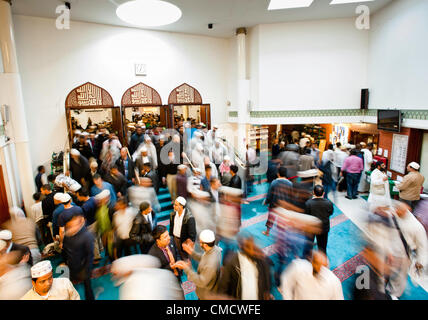 London, UK - 20 July 2012: London's Muslim faithful exit the East London Mosque during the first day of Ramadan. Stock Photo