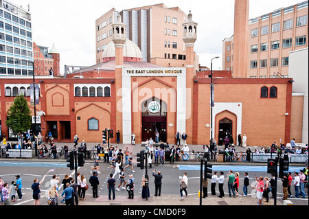 London, UK - 21 July 2012: the Olympic Torch passes in front of the East London Mosque in Whietchapel on the second day of Ramadan. Stock Photo