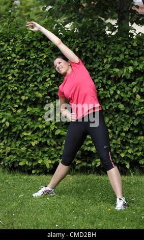 05.06.2012. Stuttgart, Germany.   Woman Warms up with a stretch before Running  Model Released leisure sports Stock Photo