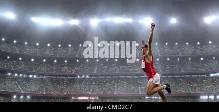 08.11.2011. Model released picture of a male athlete celebrating his victory in an athletics stadium in front of a large crowd of fans Stock Photo