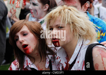 Participants in the Zombie Walk 2012 in Birmingham UK. Raising money for Birmingham Childrens Hospital. This annual event always attracts a large number of zombies who walk all around the city center scaring bewildered shoppers as they go. Credit:  Birmingham Images / Alamy Live News Stock Photo