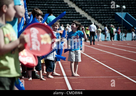 23/07/12 LONDON, UK: Children waiting for the olympic torch relay in Crystal Palace athletics stadium. Stock Photo