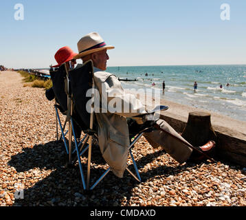 Monday 23rd July 2012, West Wittering beach, West Sussex, England, UK. A retired couple enjoy the sunshine at West Wittering beach on the  West Sussex coast. After a very wet summer good weather returned to some parts of the UK over the weekend.  South coast seaside resorts saw large numbers of holdaymakers make the most of the break in the weather. Stock Photo