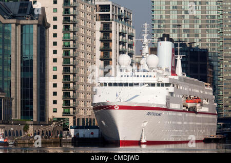 London, England, UK. Wednesday, 25 July 2012. Pictured: MS Deutschland. Luxury yachts, tall ship Stad Amsterdam and the 'love boat' cruise liner MS Deutschland, home to the German Olympic team, are at anchor in West India Dock, Canary Wharf, London, for the Olympics. Stock Photo