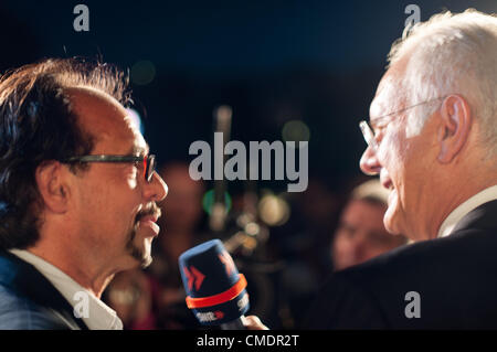 STUTTGART, GERMANY - JULY 25: Harald Schmidt, the most famous German talkmaster, is interviewing comedian Christoph Sonntag as a guest at the public viewing of the premiere of Mozart´s opera “Don Giovanni” in front of the Opera building in Stuttgart, Germany on July 25, 2012. Stock Photo