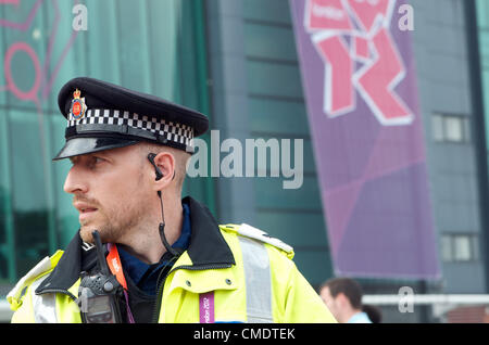 Manchester, UK. 26th July, 2012. A policeman on duty outside Old Trafford, Manchester United's ground, where the first Olympic Football matches at the ground were to be played later in the afternoon. Uruguay v United Arab Emirates was to be followed by Great Britain v Senegal, 26-07-2012 Stock Photo