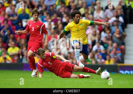 29.07.2012 Manchester, England. Brazil defender Marcelo, bal5 and Belarus midfielder Stanislaw Drahun in action during the first round group C match between Brazil and Belarus. 2012 Olympic Games mens football tournament. Stock Photo