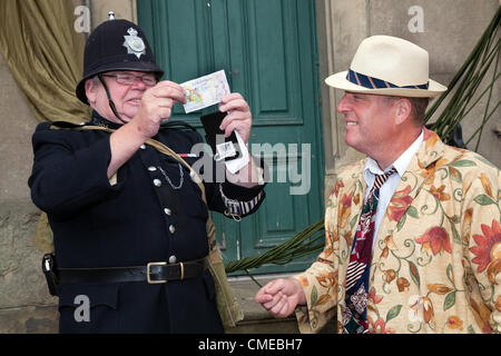Tim Handley of Grantham as Max Miller comedian in Floral Suit  Spivs Paying Police' The market place Leyburn   One of the biggest events in Leyburn's calender the 1940s Wartime Re-enactment Weekend, a summer event on July 28th & 29th 2012, Wensleydale,  North Yorkshire Dales, Richmondshire, UK Stock Photo