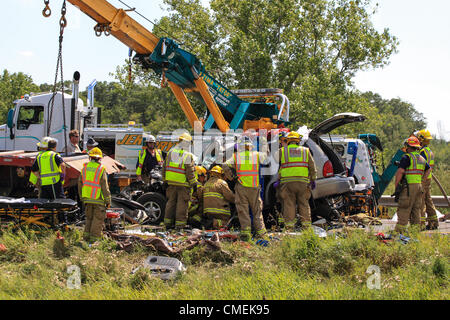Monday, 30 July, 2012 -- Emergency workers attempt to free the driver of a Sport Utility Vehicle which crashed into the rear of a flatbed semi-trailer on I-94 near mile marker 6 in Hudson, Wisconsin, USA. At least one person died in the accident.
