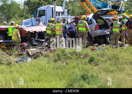 Monday, 30 July, 2012 -- Emergency workers attempt to free the driver of a Sport Utility Vehicle which crashed into the rear of a flatbed semi-trailer on I-94 near mile marker 6 in Hudson, Wisconsin, USA. At least one person died in the accident.