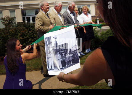 Aug. 1, 2012 - U.S. - August 1, 2012 - Left to Right Alison Reemer holds a ribbon for Wilson siblings, Spence Wilson, Bob Wilson, Kemmons Wilson Jr., Betty More and Carole West as Sarah Ann Soffer works with photographer Royce DeGrie to recreate the 1952 photo of the Wilson siblings at the ribbon cutting of the first Holiday Inn. This photo was made at the Holiday Inn Wolfchase Memphis. (Credit Image: © Alan Spearman/The Commercial Appeal/ZUMAPRESS.com) Stock Photo