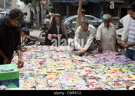 People buy Eid cards at a roadside stall at Denso Hall area  ahead of Eid-ul-Fitar during the Holy Month of Ramadan-ul-Mubarak in Karachi on Thursday,  August 02, 2012. Stock Photo