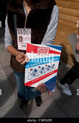 2 Aug 2012- CARDIFF WALES UK-  Big Issue seller vendor selling London Olympic 2012 Games cycling magazines on the streets of Cardiff Wales UK Stock Photo