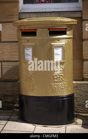 Sherborne, Dorset, UK Monday 6 August 2012. Royal mail gold painted post box at Sherborne, Dorset to recognise Olympic gold medalist Peter Wilson gold medal winner at Olympics London 2012 games. golden postbox  golden post box gold postbox gold post box gold mailbox golden mailbox gold letterbox golden letterbox gold mail box golden mail box. Stock Photo