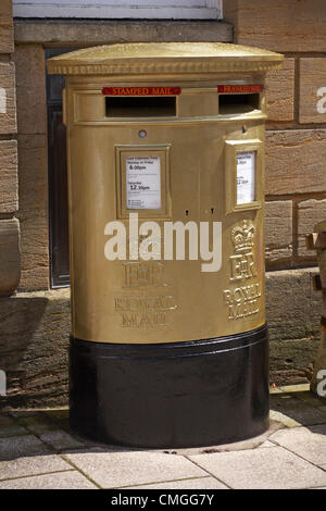 Sherborne, Dorset, UK Monday 6 August 2012. Royal mail gold painted post box at Sherborne, Dorset to recognise Olympic gold medalist Peter Wilson gold medal winner at Olympics London 2012 games. golden postbox  golden post box gold postbox gold post box gold mailbox golden mailbox gold letterbox golden letterbox gold mail box golden mail box. Stock Photo