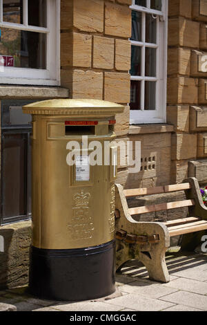 Sherborne, Dorset, UK Monday 6 August 2012. Royal mail gold painted post box at Sherborne, Dorset to recognise Olympic gold medalist Peter Wilson gold medal winner at Olympics London 2012 games. golden postbox  golden post box gold postbox gold post box gold mailbox golden mailbox gold letterbox golden letterbox gold mail box golden mail box. Stock Photo